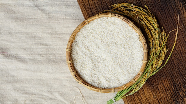 Ears of Thai rice and rice on table