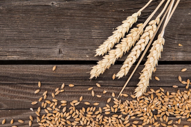 Ears of wheat on old wooden table