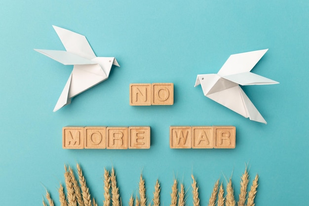 Ears of wheat and two white birds as a symbol of peace on a blue background There is no war