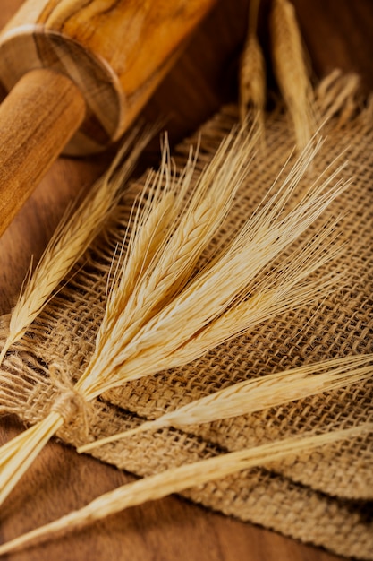 Ears of wheat on wooden background