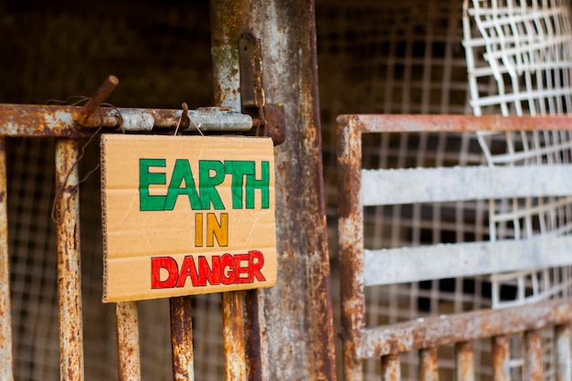 Earth in danger title on cardboard