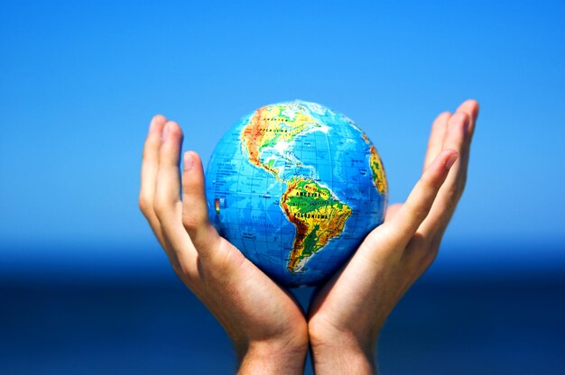 Photo earth globe in hands conceptual image