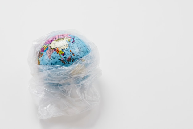 earth globe wrapped in trash plastic bag 