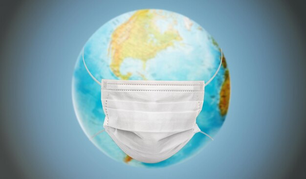 earth planet globe in protective medical mask