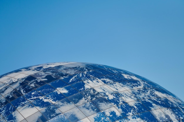 Earth planet modern building with clouds and blue sky ecological architectural concept