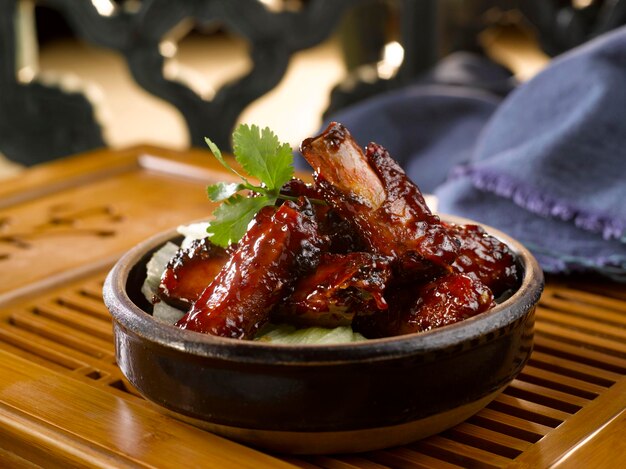 Earthen Bowl Ribs served in a pot isolated on table side view