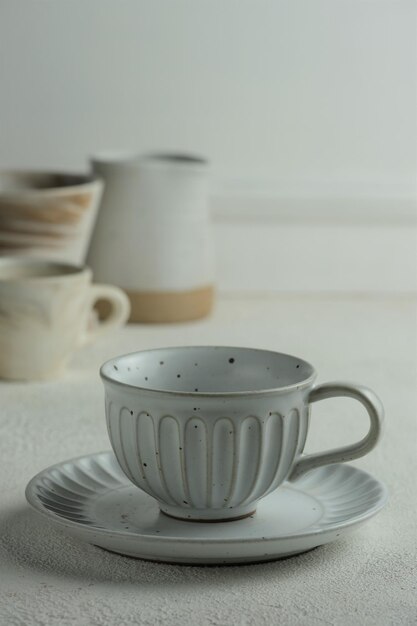 Earthen cup and saucer on white background