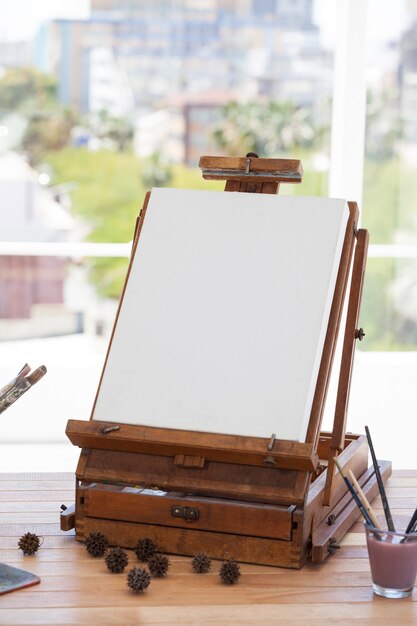 Photo easel with blank canvas in drawing room