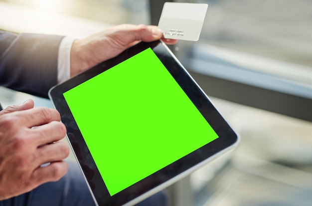 The easiest way to connect in business Cropped shot of an unrecognizable businessman using a digital tablet with a green screen in a modern office