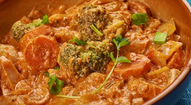 East African cuisine - Ethiopian Inspired Berbere Chicken Curry, Traditional assorted African  dishes, Top view.