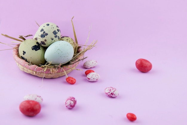 Easter background, eggs in a basket on a pink background