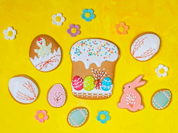 Easter background gingerbread bunnies and easter eggs on yellow background