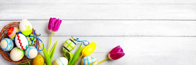 Easter background with colorful easter eggs on wooden background