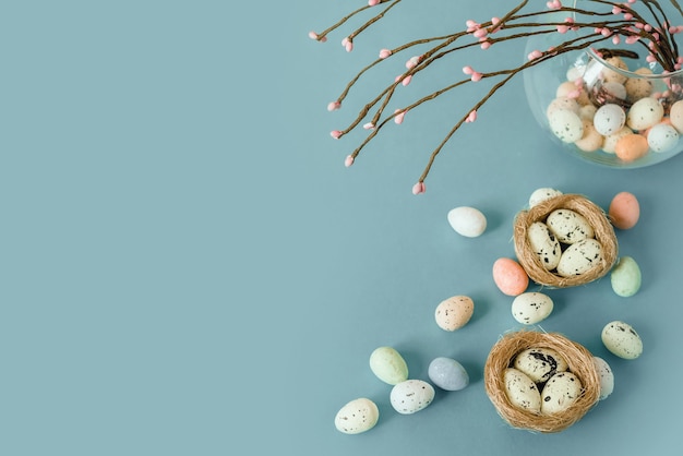 Easter background with colourful Easter eggs with bird's nest and decorative catkins