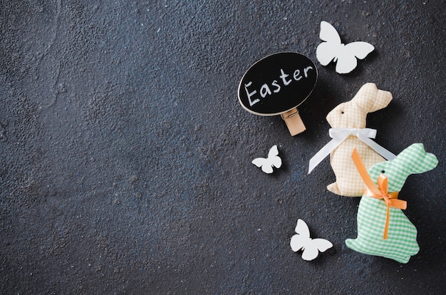 Easter background with decorative rabbit, butterflies and inscription easter.