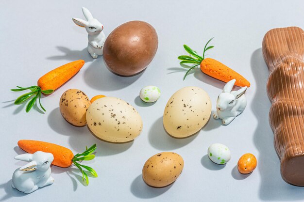 Easter background with eggs rabbits and carrots festive spring composition with traditional symbols modern hard light dark shadow flat lay top view