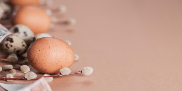 Easter background with natural color eggs and brown feathers