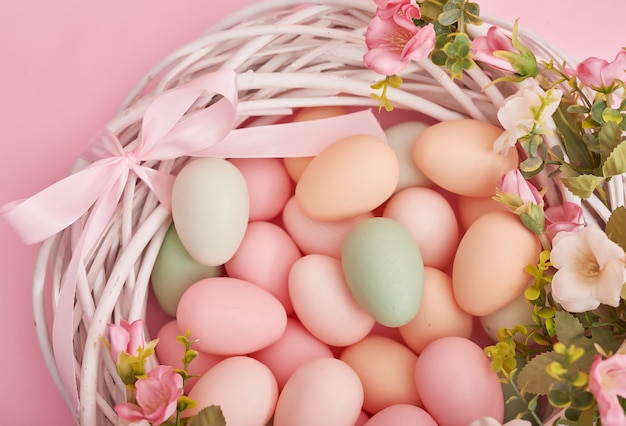 Easter background with painted eggs in nest.