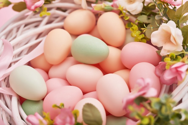 Easter background with painted eggs in nest.