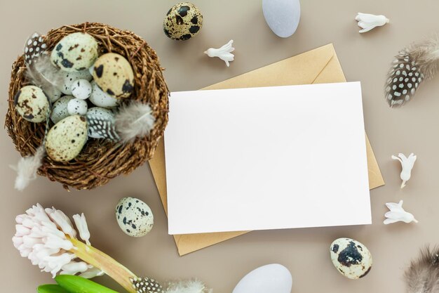 Easter background with quail nest empty letter and easter eggs on a neutral background Flat lay greeting card with space for text Easter decoration Easter design template