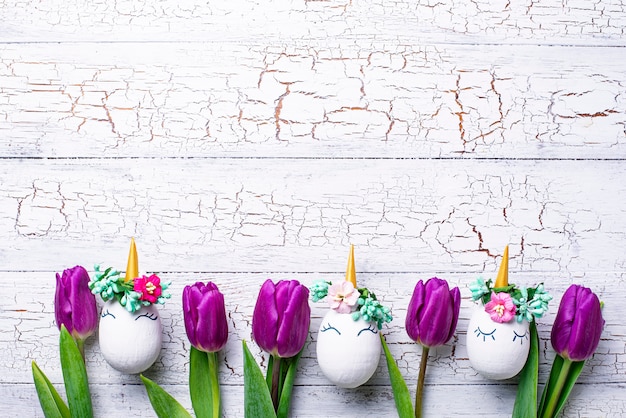 Easter background with tulip and unicorn eggs