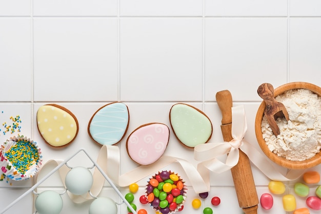 Easter baking background. Concept of cooking traditional festive food Easter gingerbread and bread on white background.