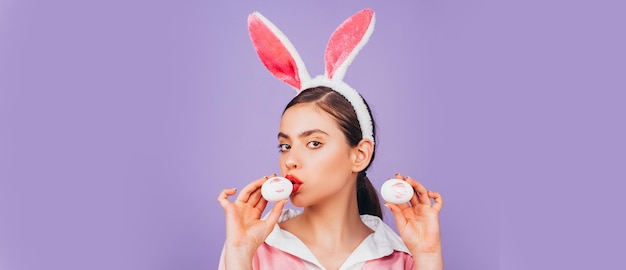 Easter banner with bunny woman easter woman lips and easter lipstick kiss imprint on easter egg young woman in rabbit bunny ears portrait of a happy woman in bunny ears