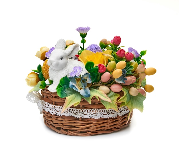 Easter basket from a flower arrangement and a hare on white background