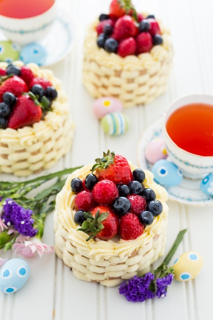 Easter basket mini cakes with glazed fresh fruit on top.