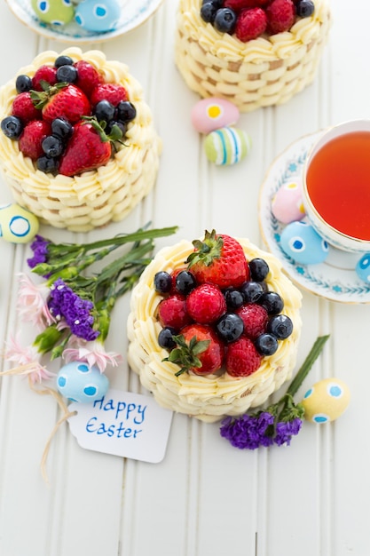 Easter basket mini cakes with glazed fresh fruit on top.