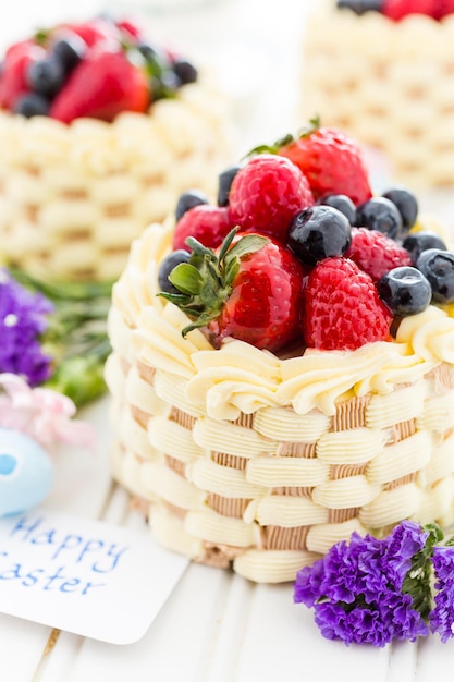 Easter basket mini cakes with glazed fresh fruit on top.