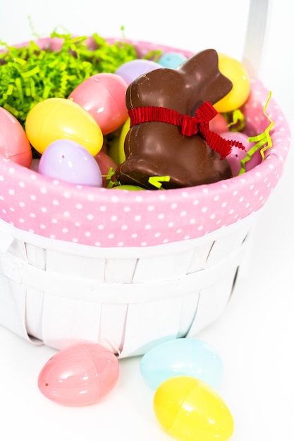 Easter basket with easter eggs on a white background.