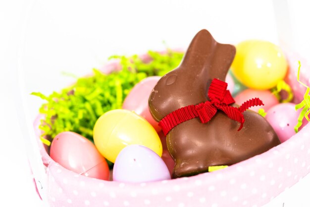 Easter basket with easter eggs on a white background.