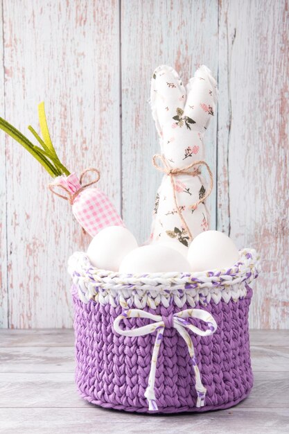 Easter basket with eggs and Easter gnome with rabbit ears Easter Spring Holiday