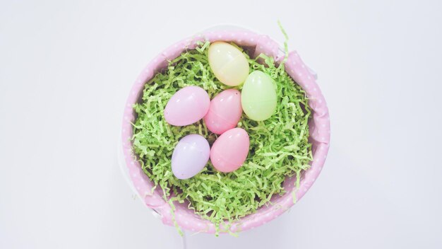 Easter basket with green paper grass on a white background.