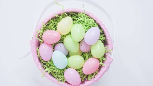 Easter basket with green paper grass on a white background.