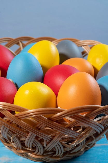 Easter basket with straw and colored eggs