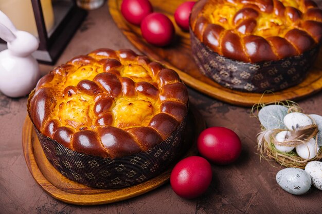 Easter bread and eggs on wood