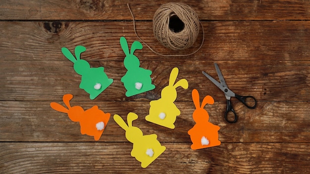 Easter bunnies made of paper on a wooden surface