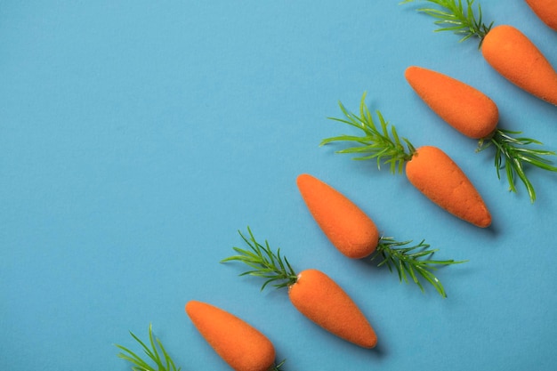 Easter bunny carrots on a blue background