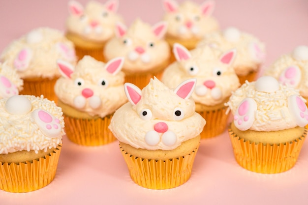 Easter bunny cupcakes on pink background.