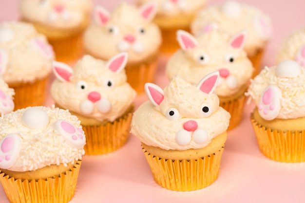 Easter bunny cupcakes on pink background.