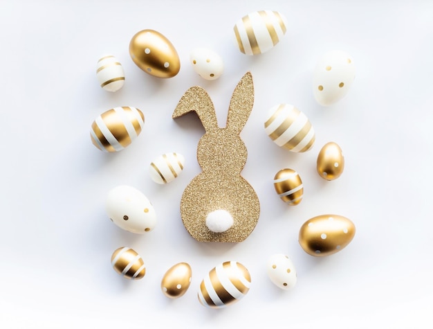 Easter bunny and golden eggs on white background Happy Easter minimal concept greeting card Copy space soft selective focus