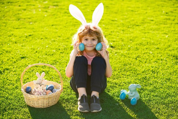 Easter bunny kids child boy in bunny easter ears painting eggs funny boy easter bunny kids