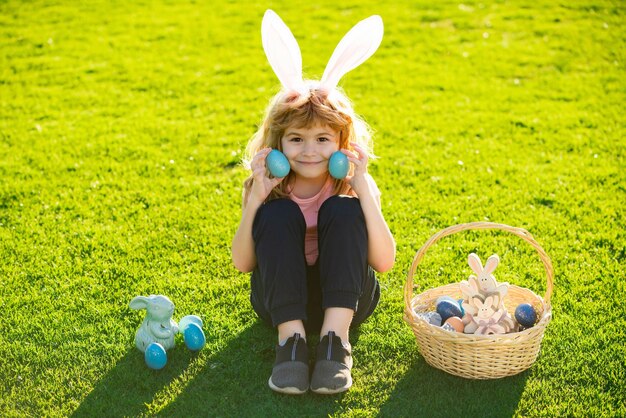 Easter bunny kids child boy in bunny easter ears painting eggs funny boy easter bunny kids