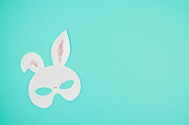 Easter bunny mask on a pastel blue background