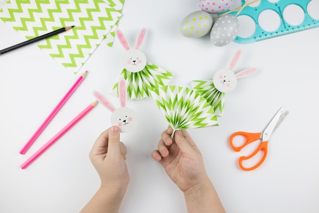 Easter bunny out of paper. DIY step by step. Crafts concept for kids.