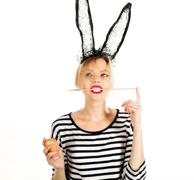 easter bunny, painting eggs, woman with paint brush in mouth, egg hunt.
