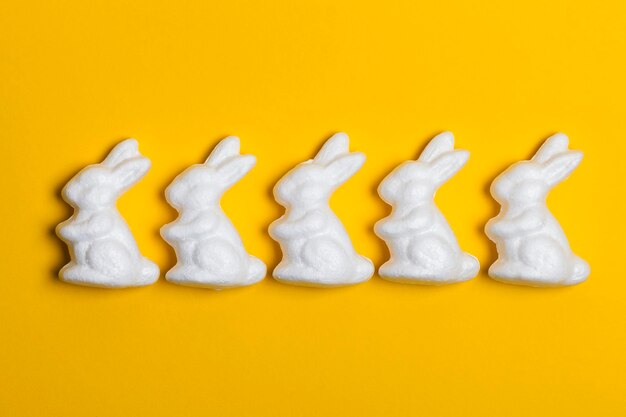 Easter bunny rabbits on a bright yellow background