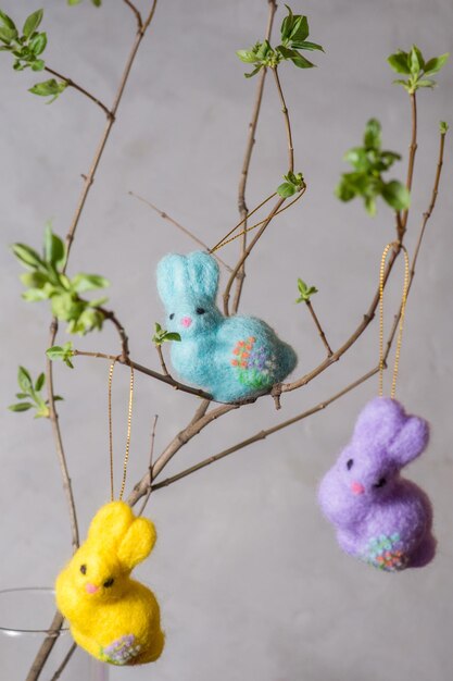 Easter bunnys on a young branch with small green leaves